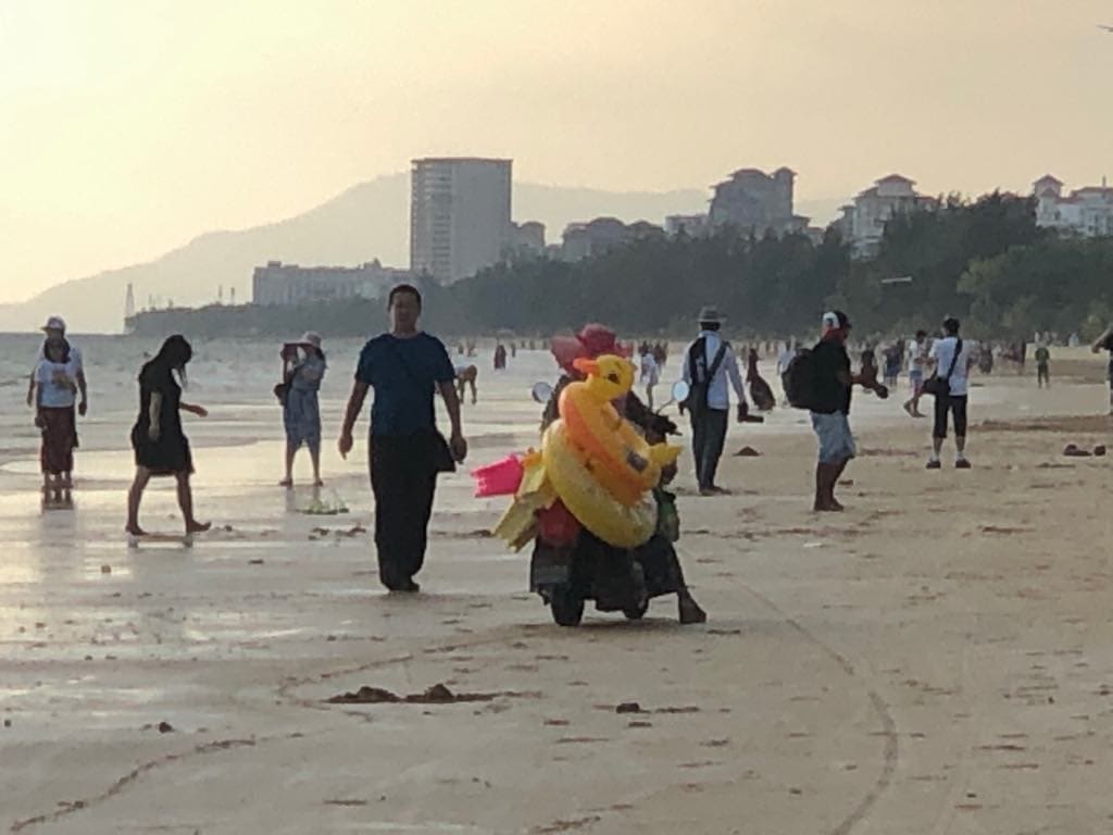 things to do in Sanya, Sanya travel guide, street sellers in the beach by motorbike