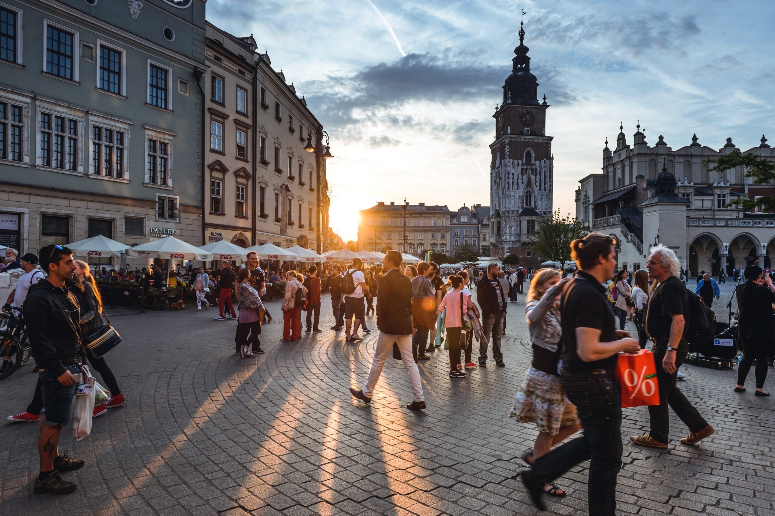 WHAT TO WEAR IN POLAND: OUR POLAND PACKING LIST AND WHAT TO PACK FOR POLAND 4 Tourists on Main Market Square in Krakow, Poland.
What To Wear In Poland, Poland Packing List, What To Pack For Poland