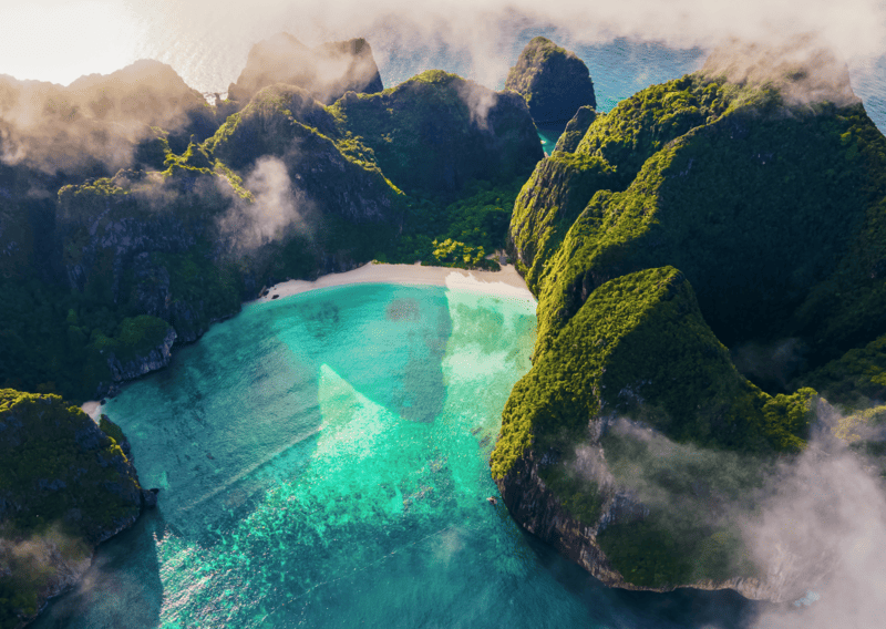 Thailand vs Philippines - A shot of Maya Bay from the top. Limestones are found in Thailand and Philippines in Palawan