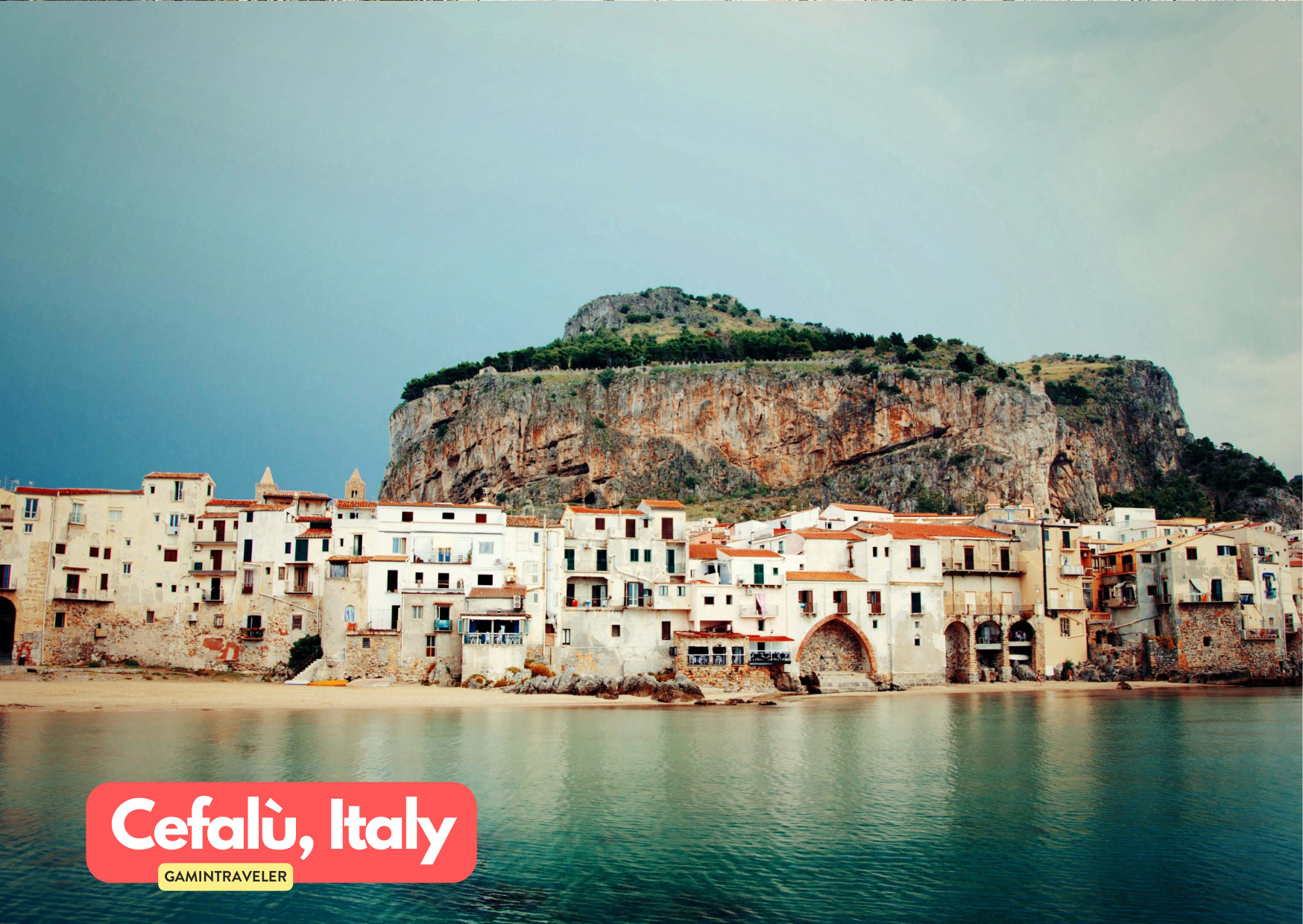 a group of buildings on a beach in Cefalu Italy