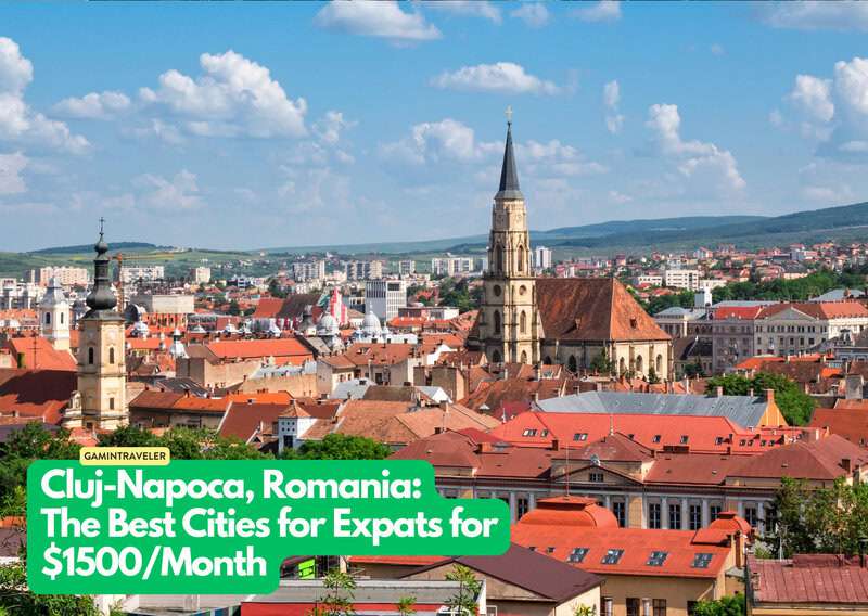 a city with a steeple and red roofs